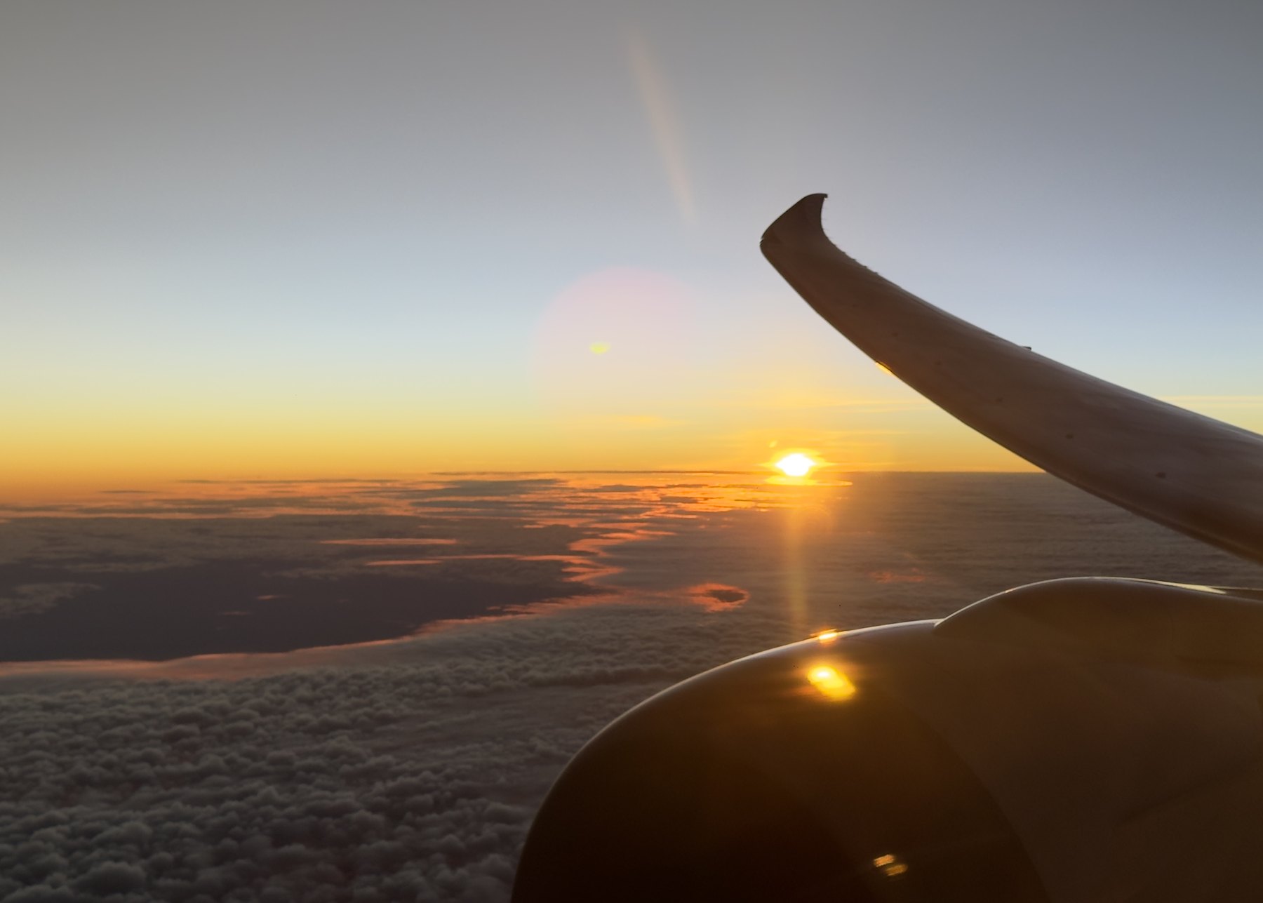 Sunset from an aircraft window on a one-way flight
