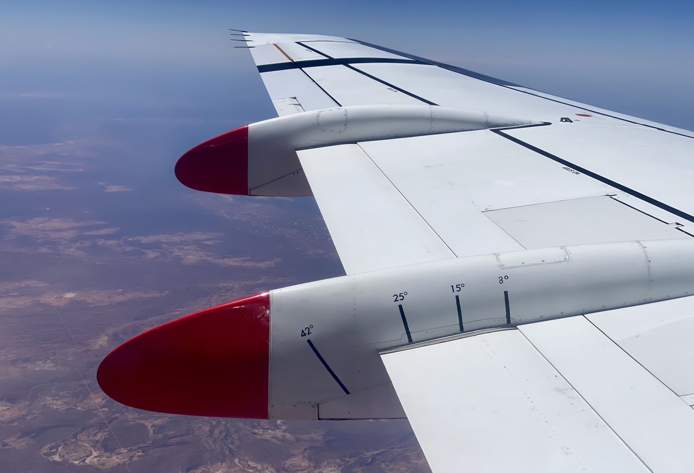 Aircraft wing over dry inland terrain